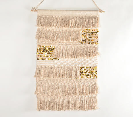 Sequin cotton wall hanging on a painted plaster wall