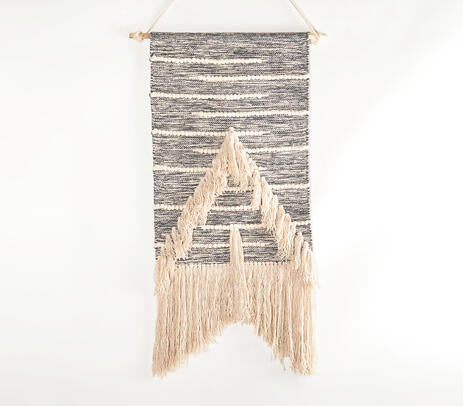 Arrowhead wool and cotton wall hanging above a sofa