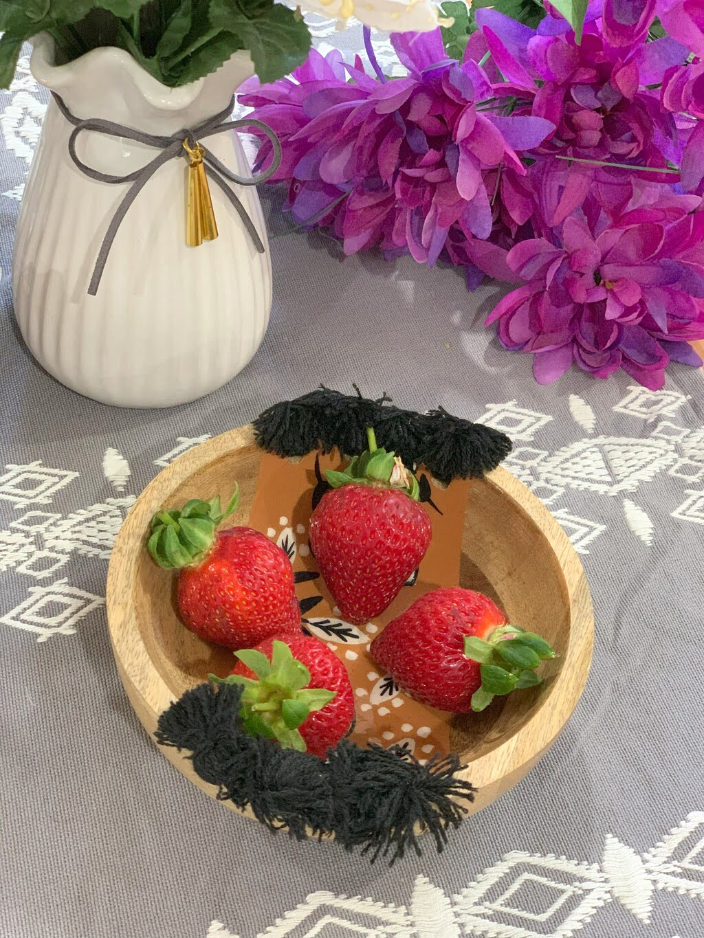 Tasseled wooden bowl back view