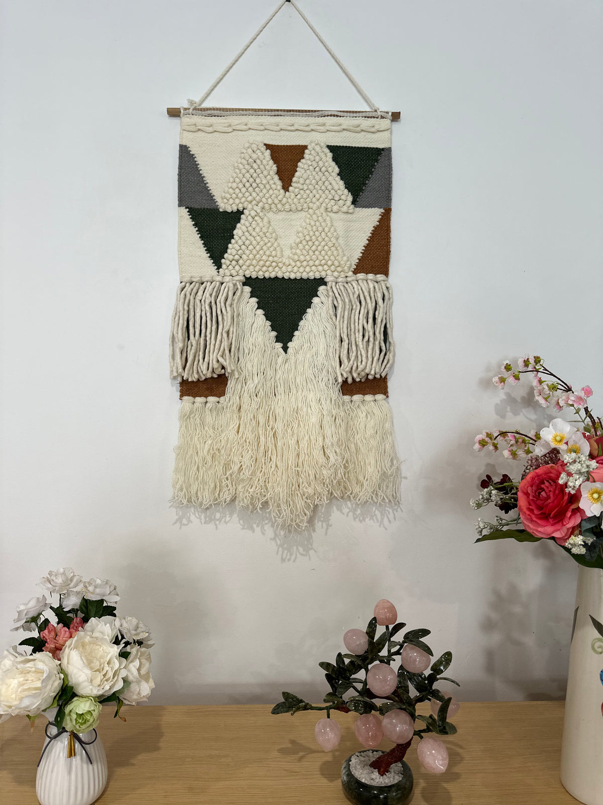 Loop and pile wool wall hanging above a sofa
