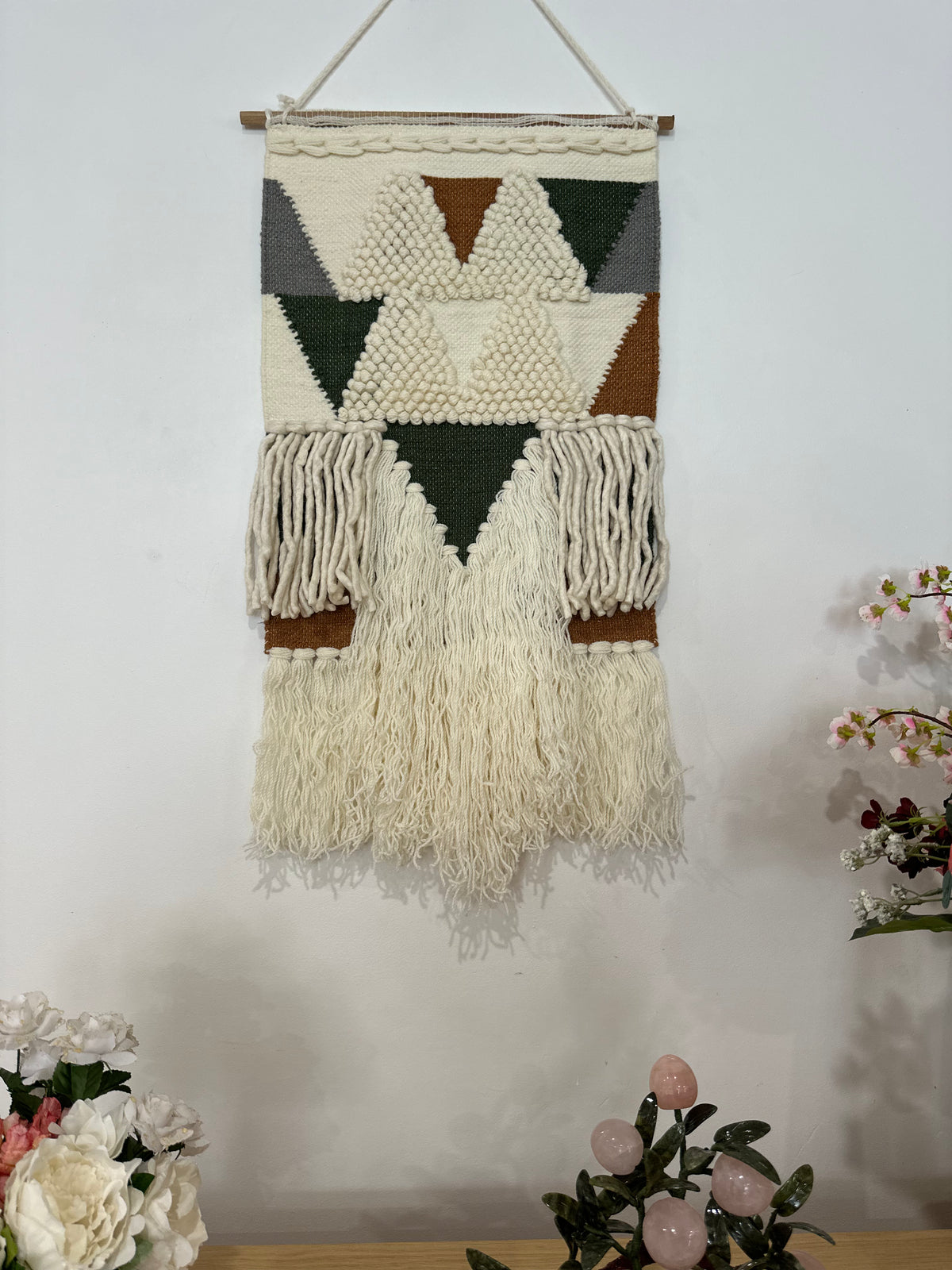 Loop and pile wool wall hanging shown at an angle