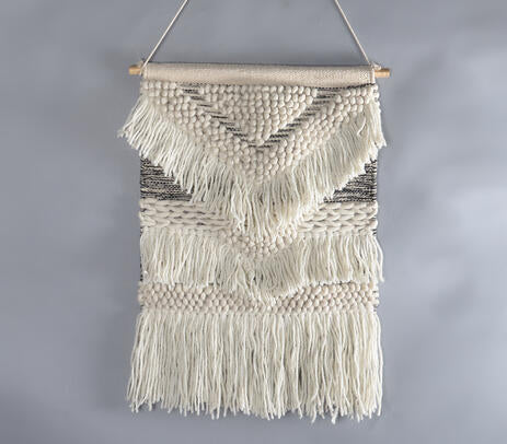 Multicolour wool and cotton wall hanging on a plain wall