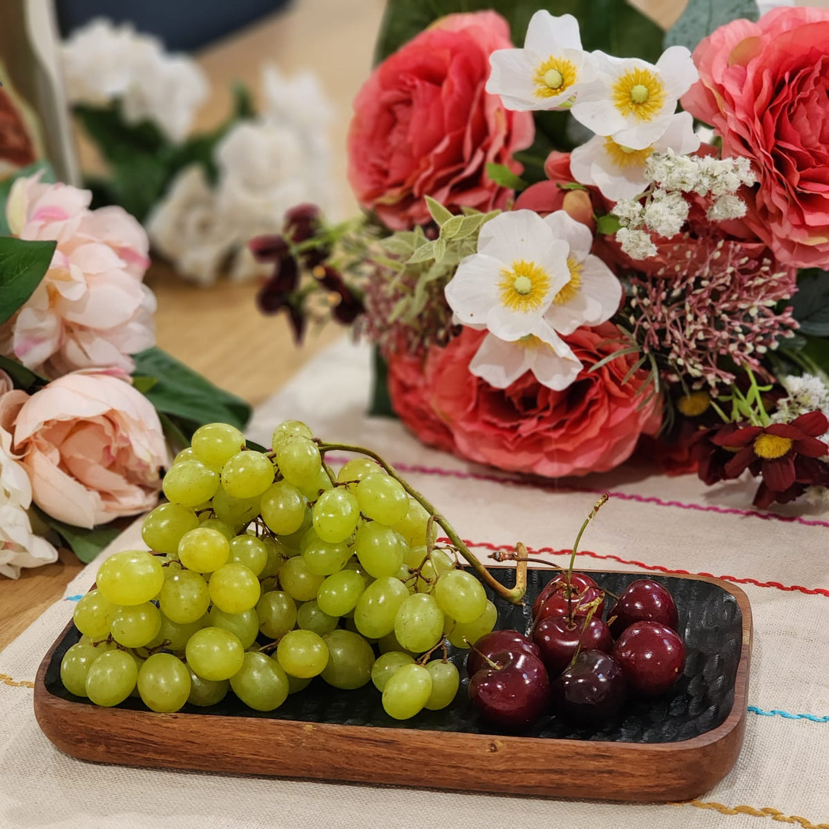 Enamelled acacia tray styled with food