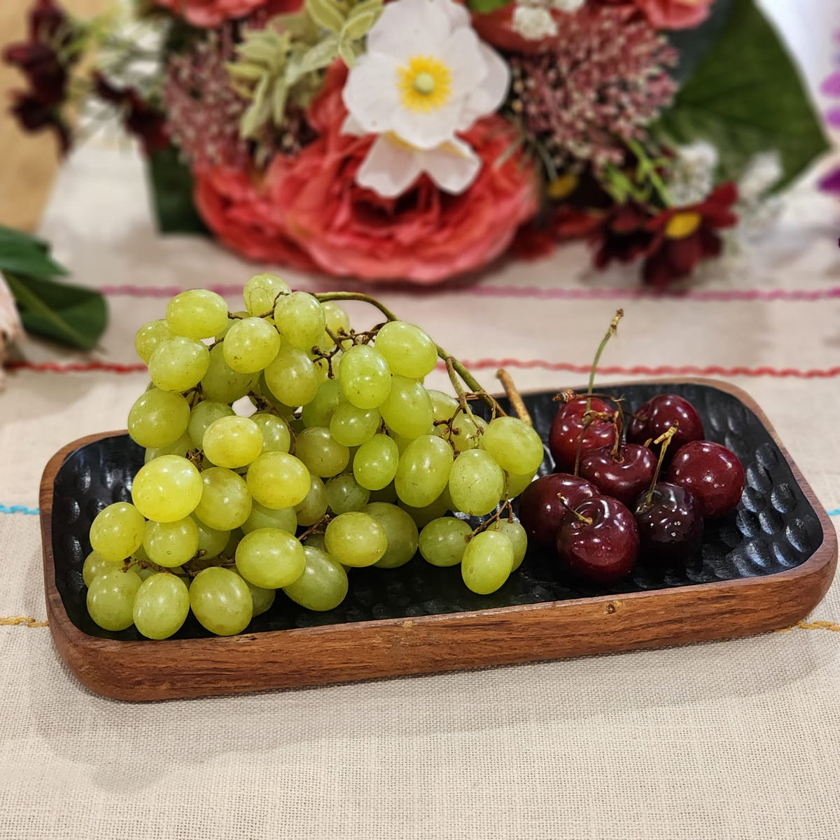 Enamelled acacia tray at an angle