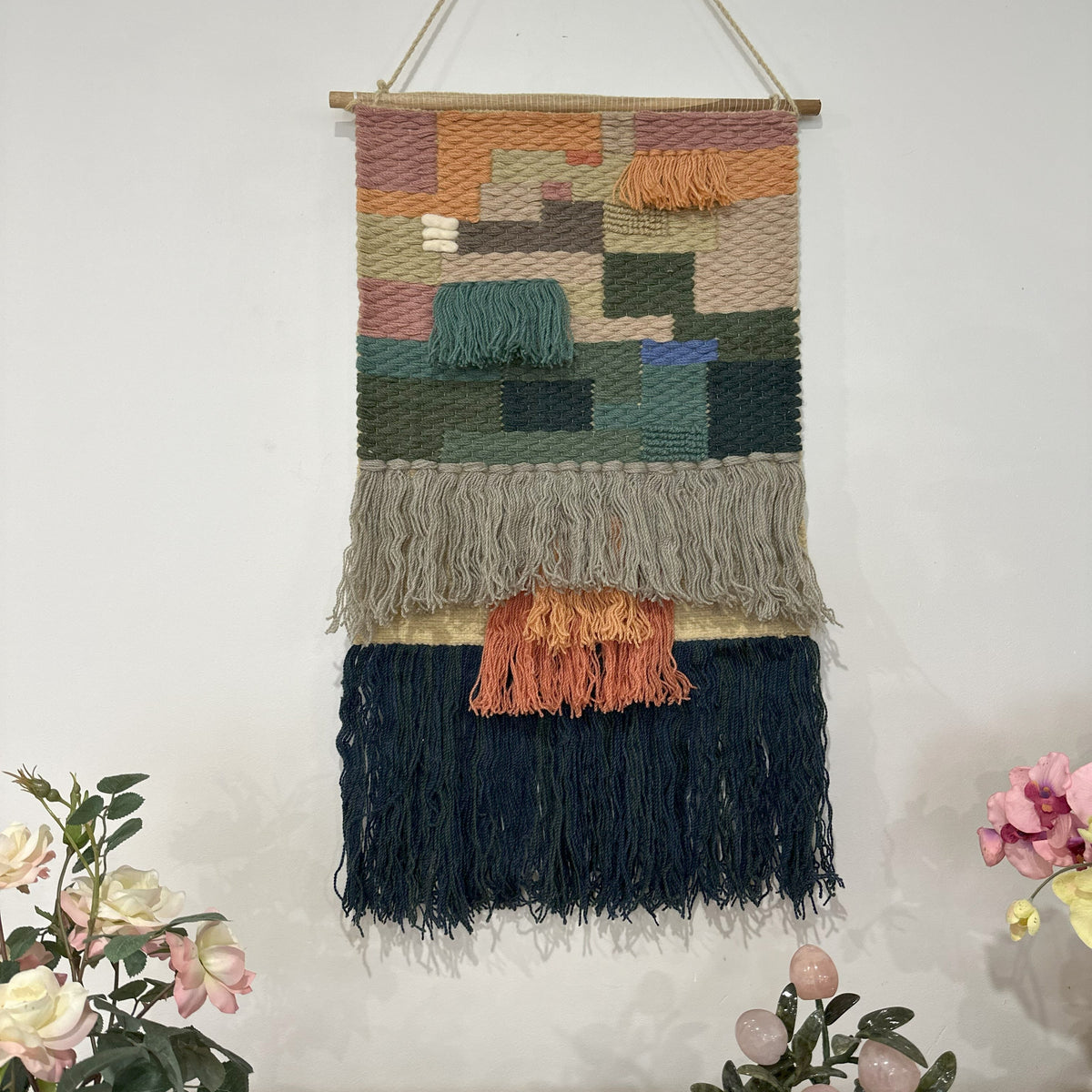 Earthy diamond wool wall hanging shown at an angle