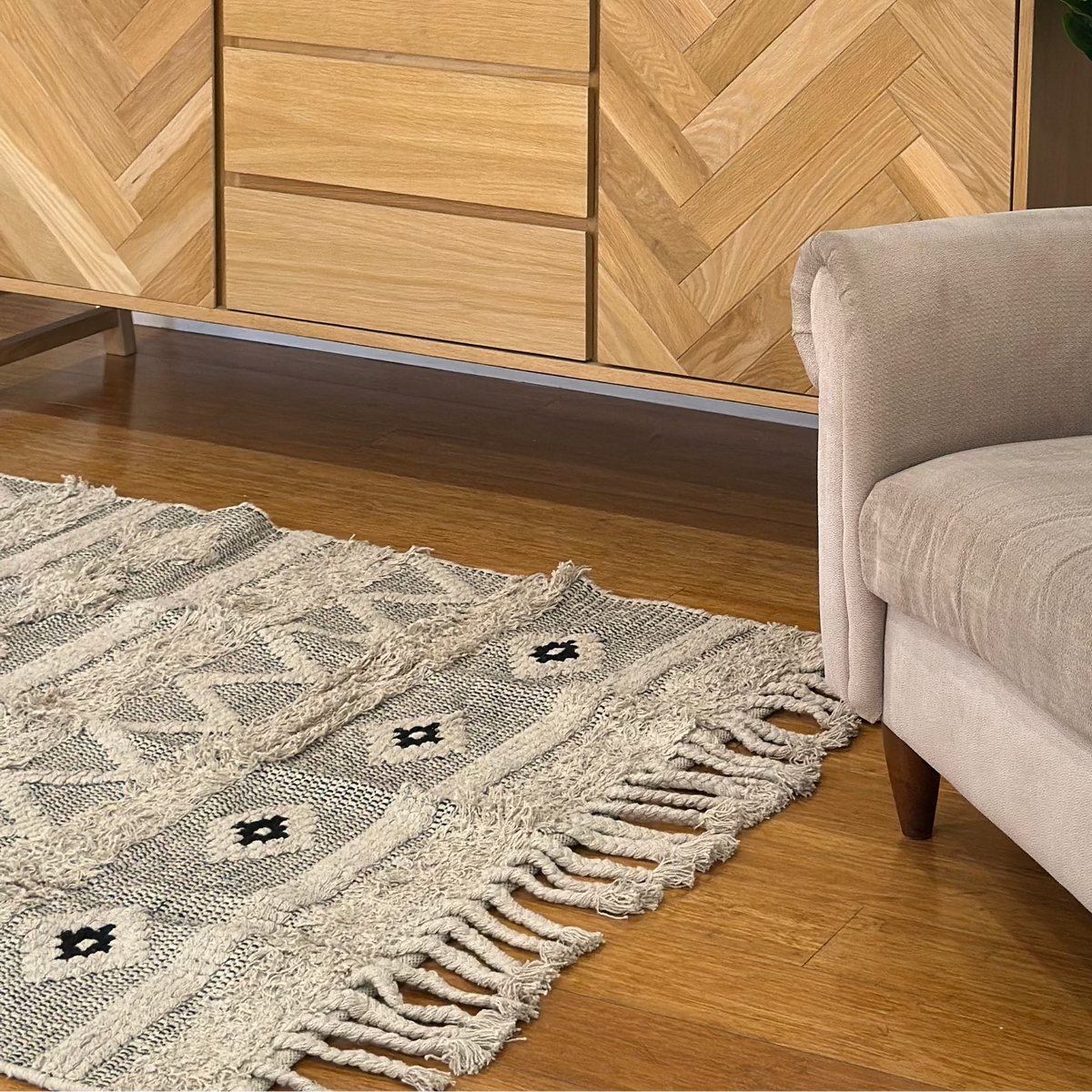 Rug shown partly turned back to reveal its reverse