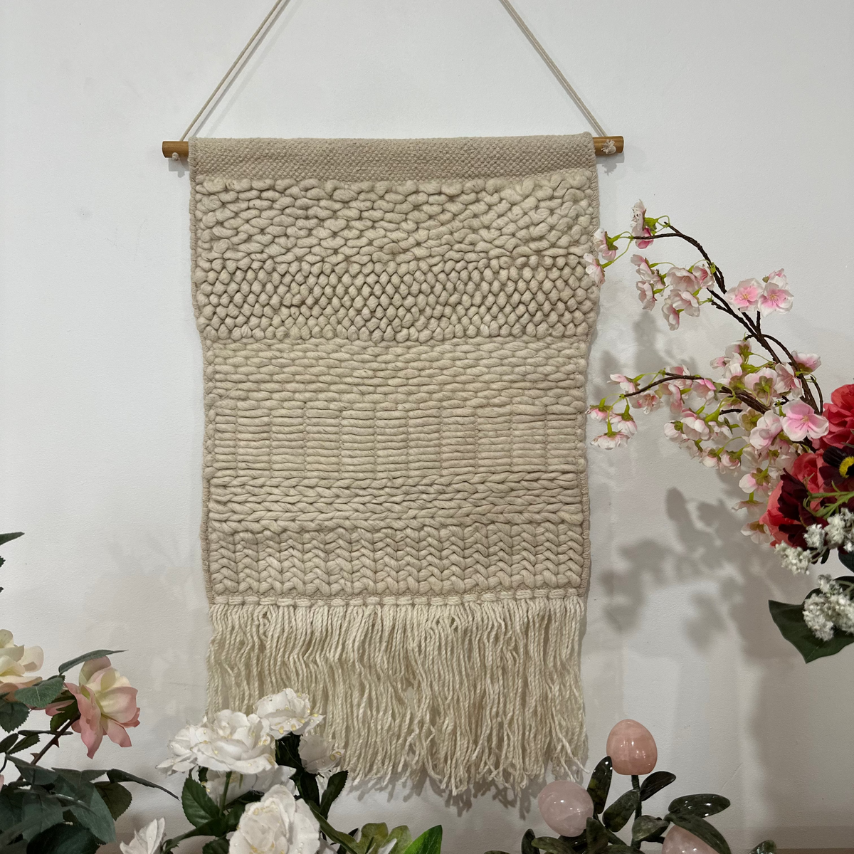 Boho wool fringe wall hanging above a console table