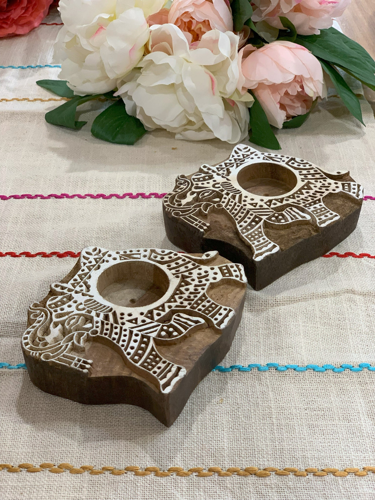 Wooden elephant tealight holders in lifestyle setting
