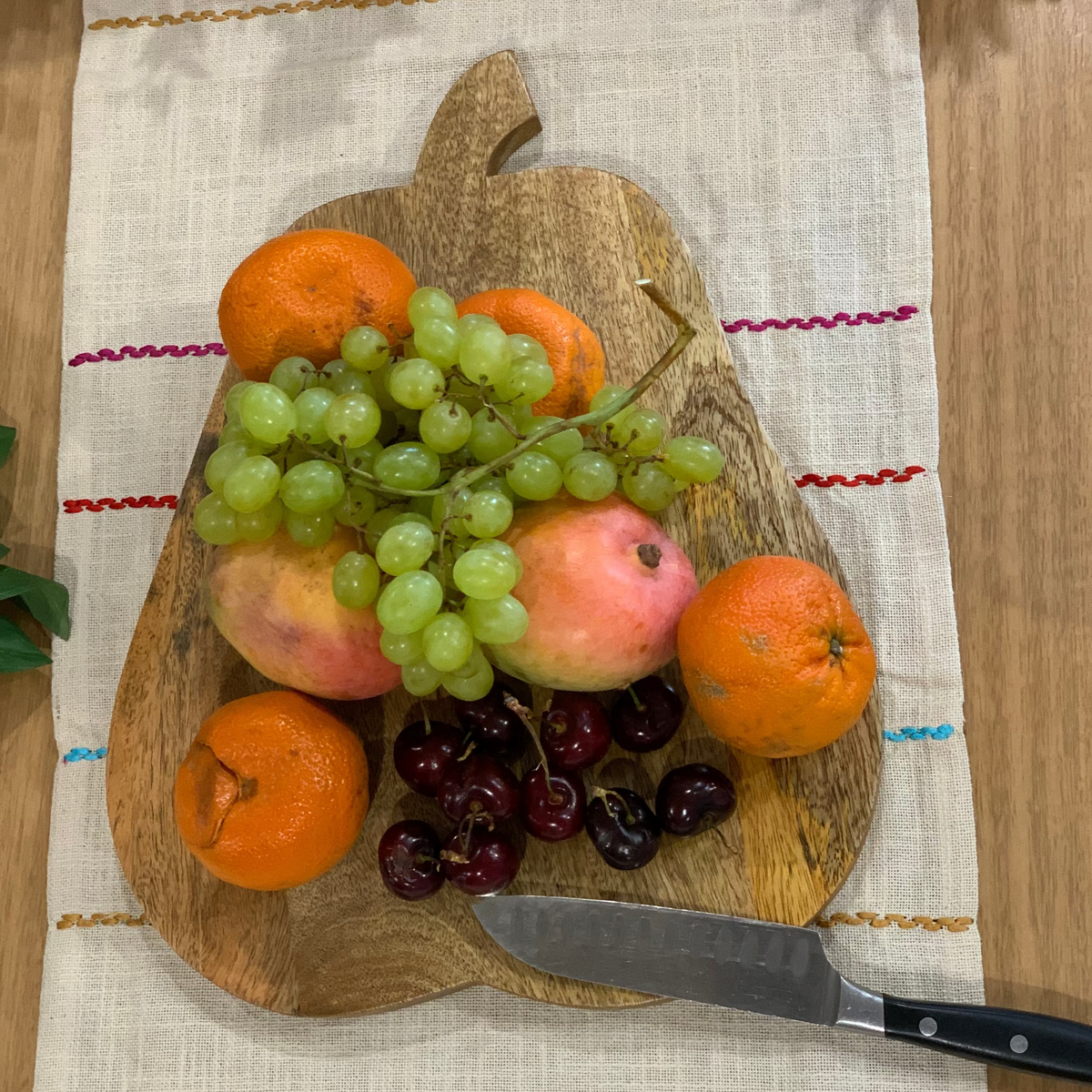 Pear shaped chopping board paired with tableware