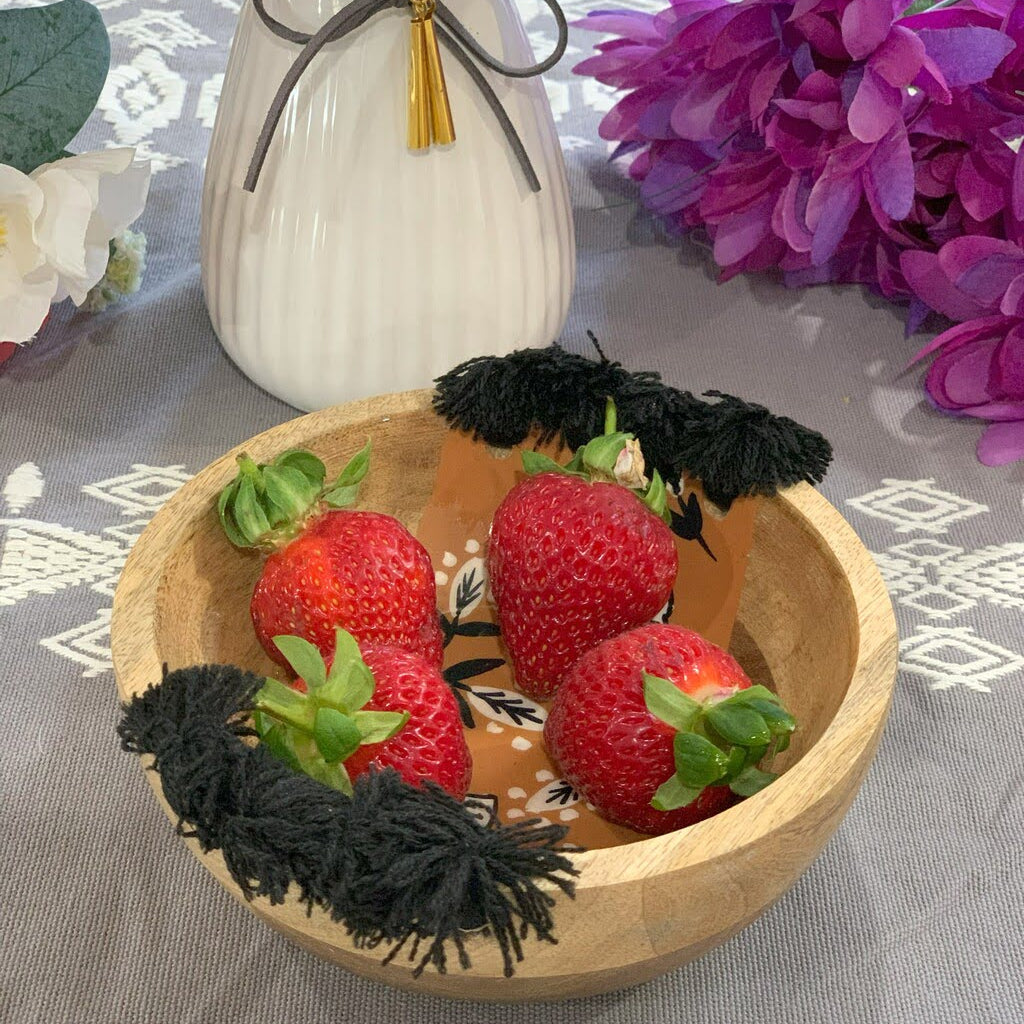 Tasseled wooden bowl lifestyle shot