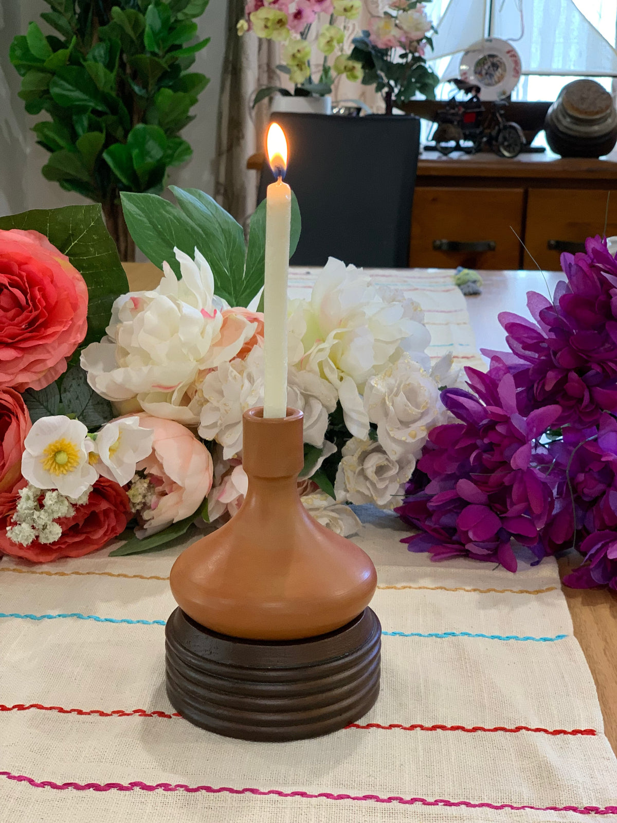 Terracotta holder with wooden base in boho bedroom