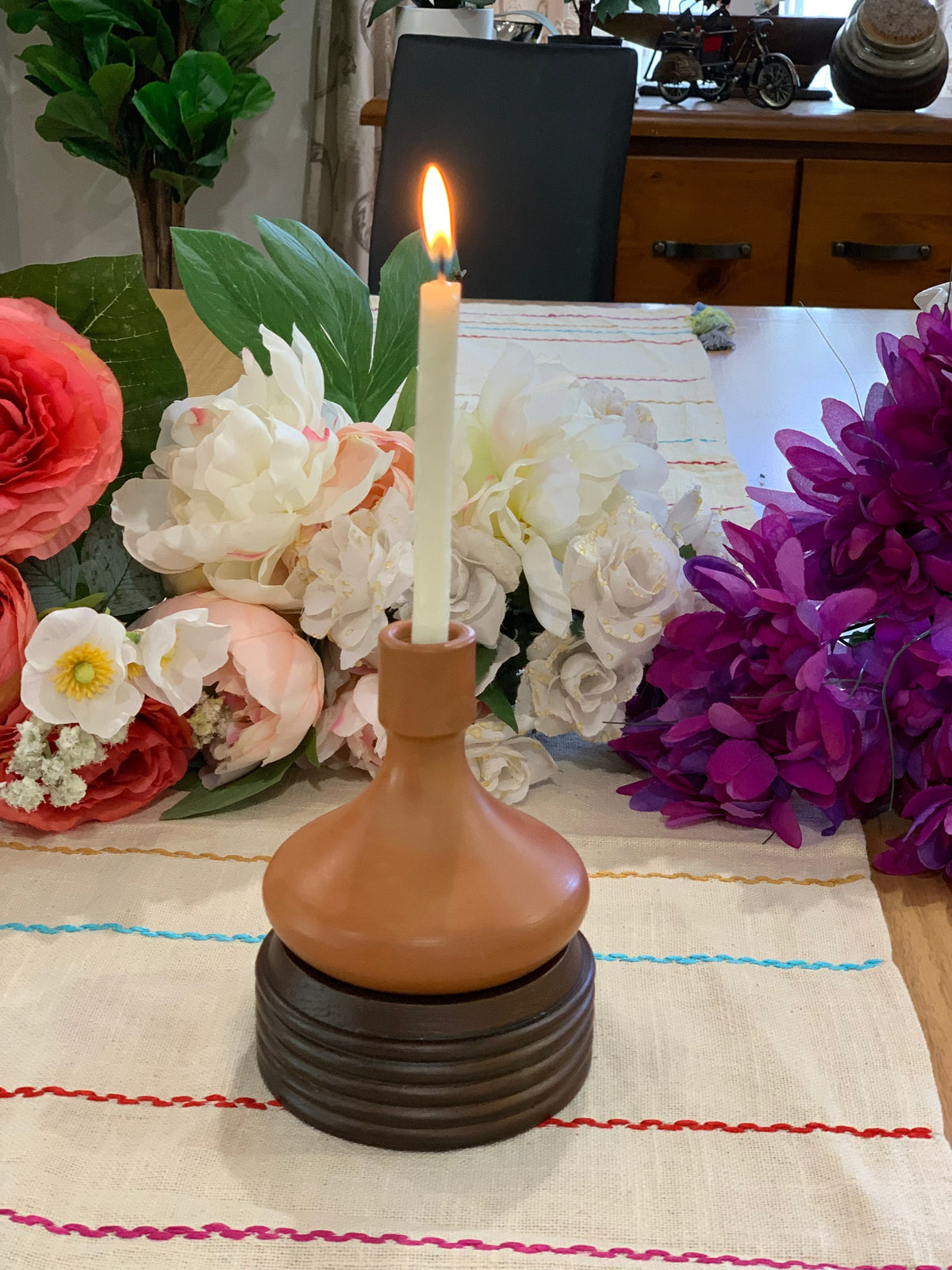 Earthy terracotta candle holder with small pillar candle on top