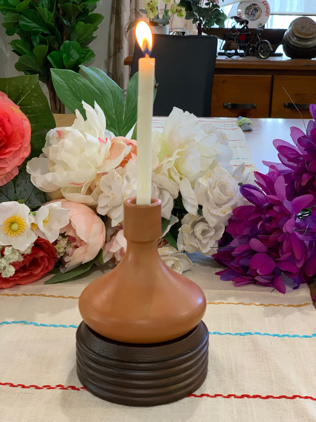 Terracotta candle holder close-up of ribbed wooden stand