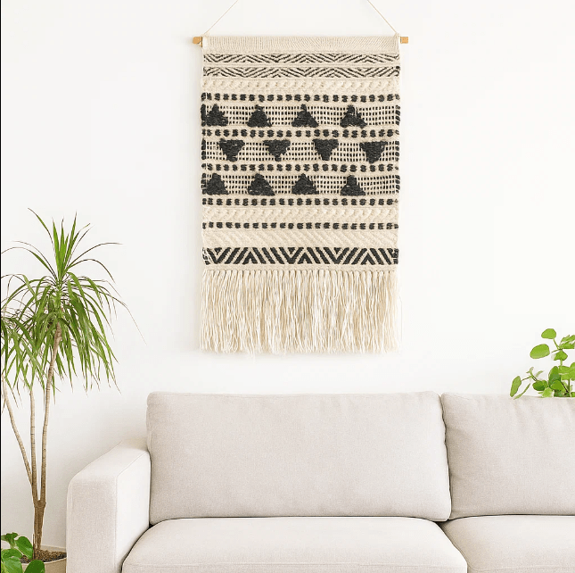 Textured wool and cotton wall hanging on a plain wall