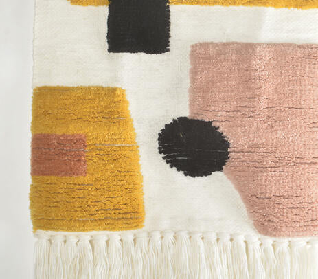 Ombre tassel wool wall hanging above a sofa