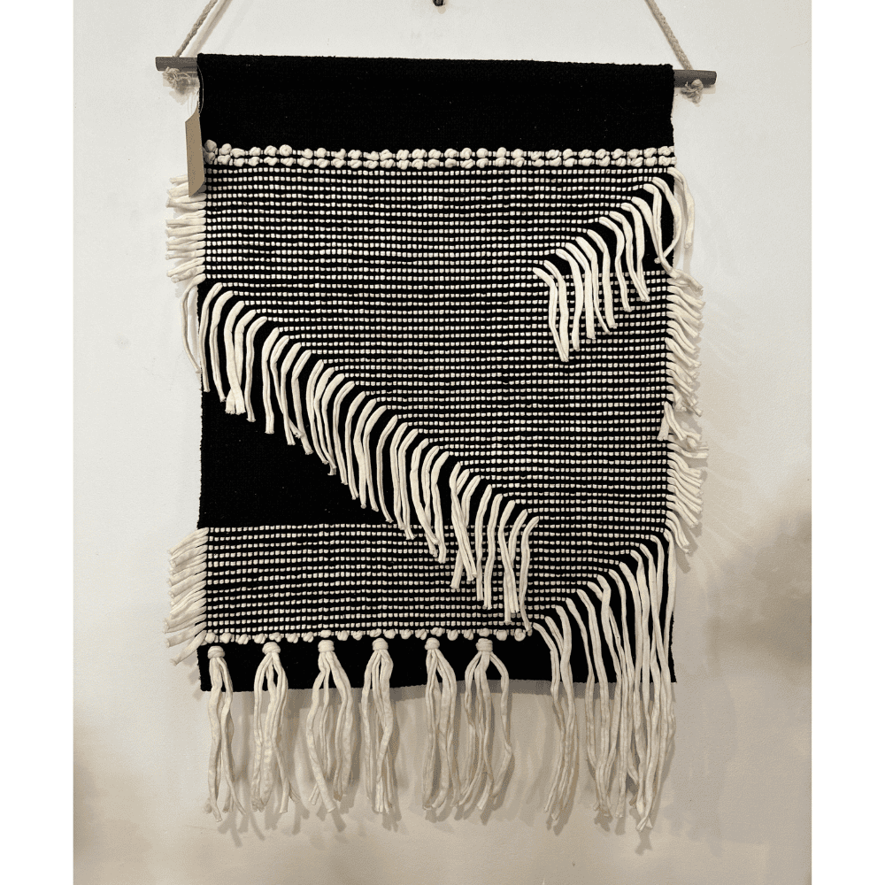 Monochrome cotton fringe wall hanging detail of cotton yarn
