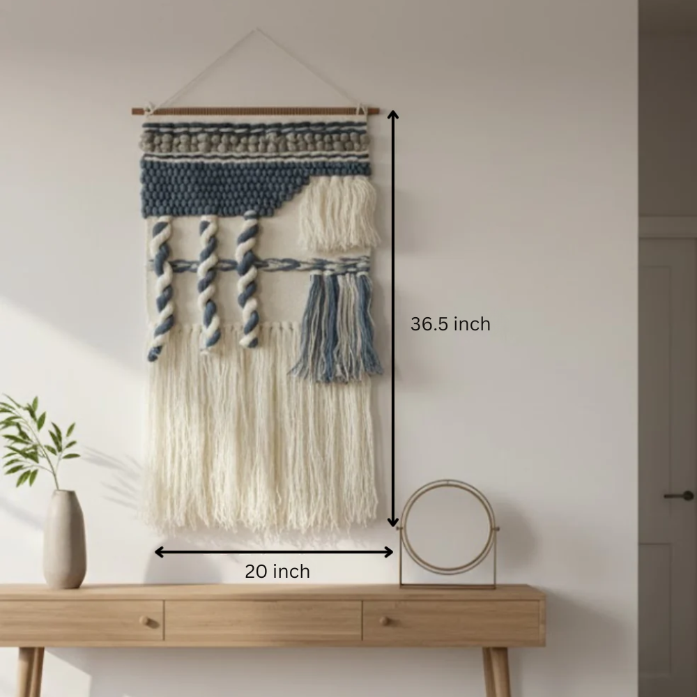 Tufted abstract wool wall hanging on a plain wall