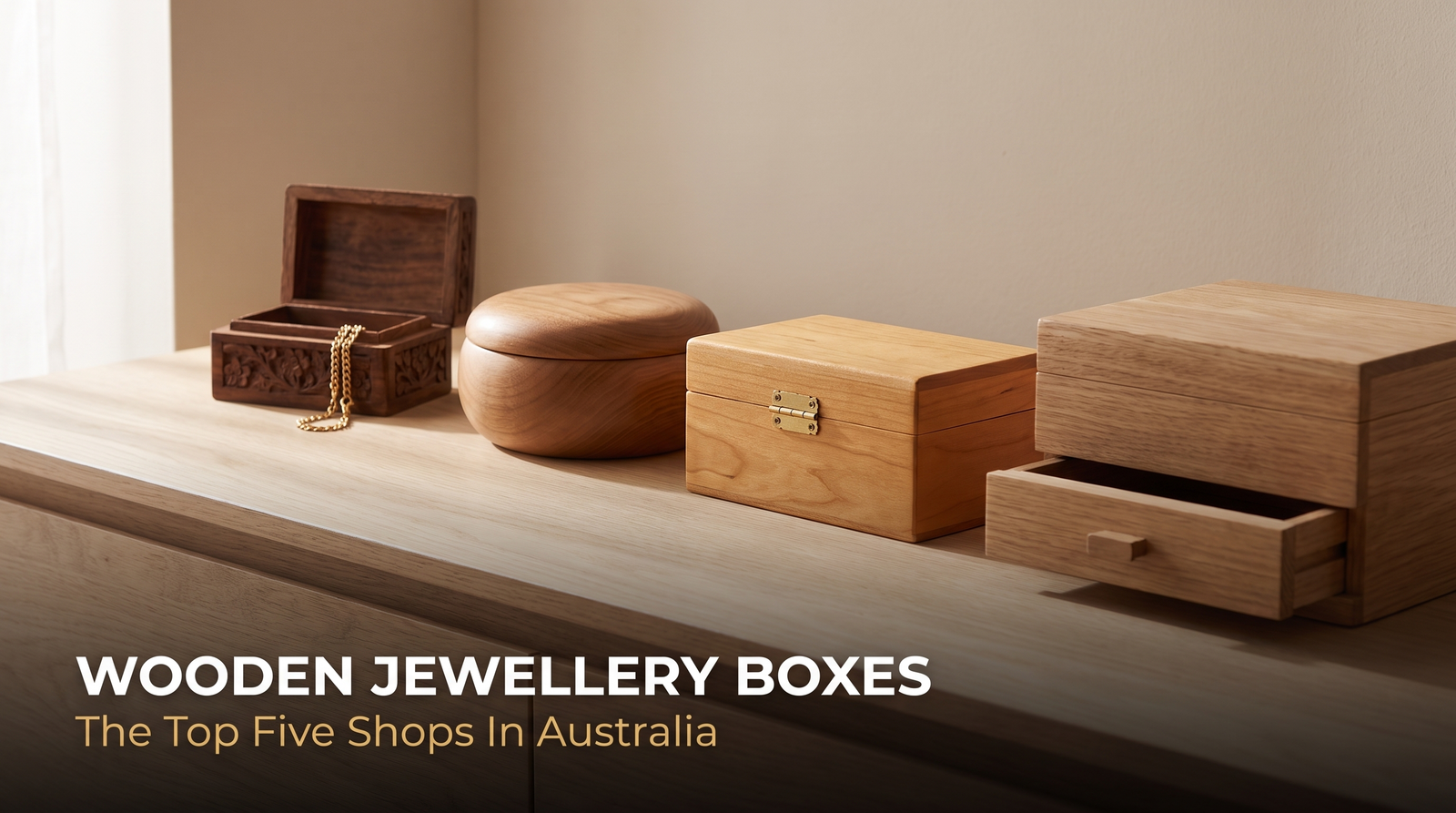 Four wooden jewellery boxes on a dresser, one open showing a gold chain inside