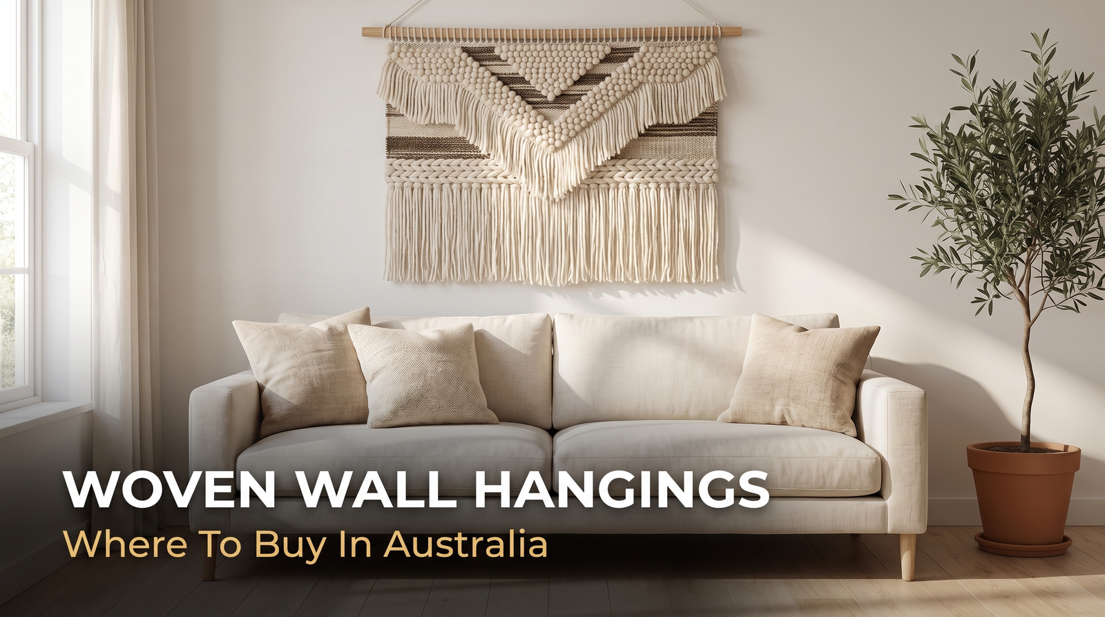 Large handwoven wool wall hanging with fringe above a cream sofa in an Australian living room