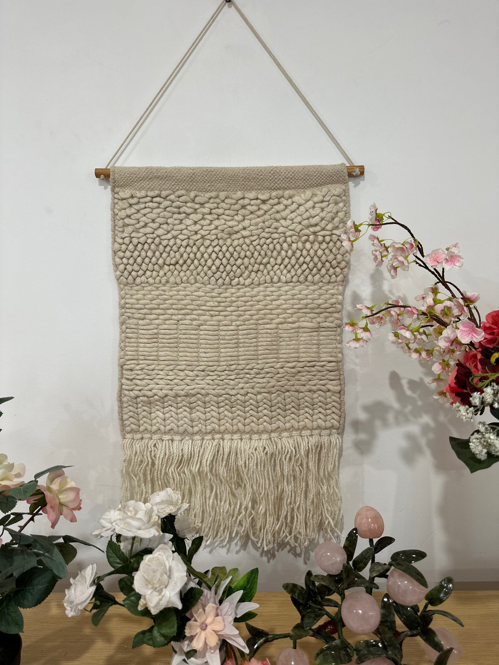 Fringed woolen wall hanging in beige and cream with textured weave – boho home decor for living room or bedroom