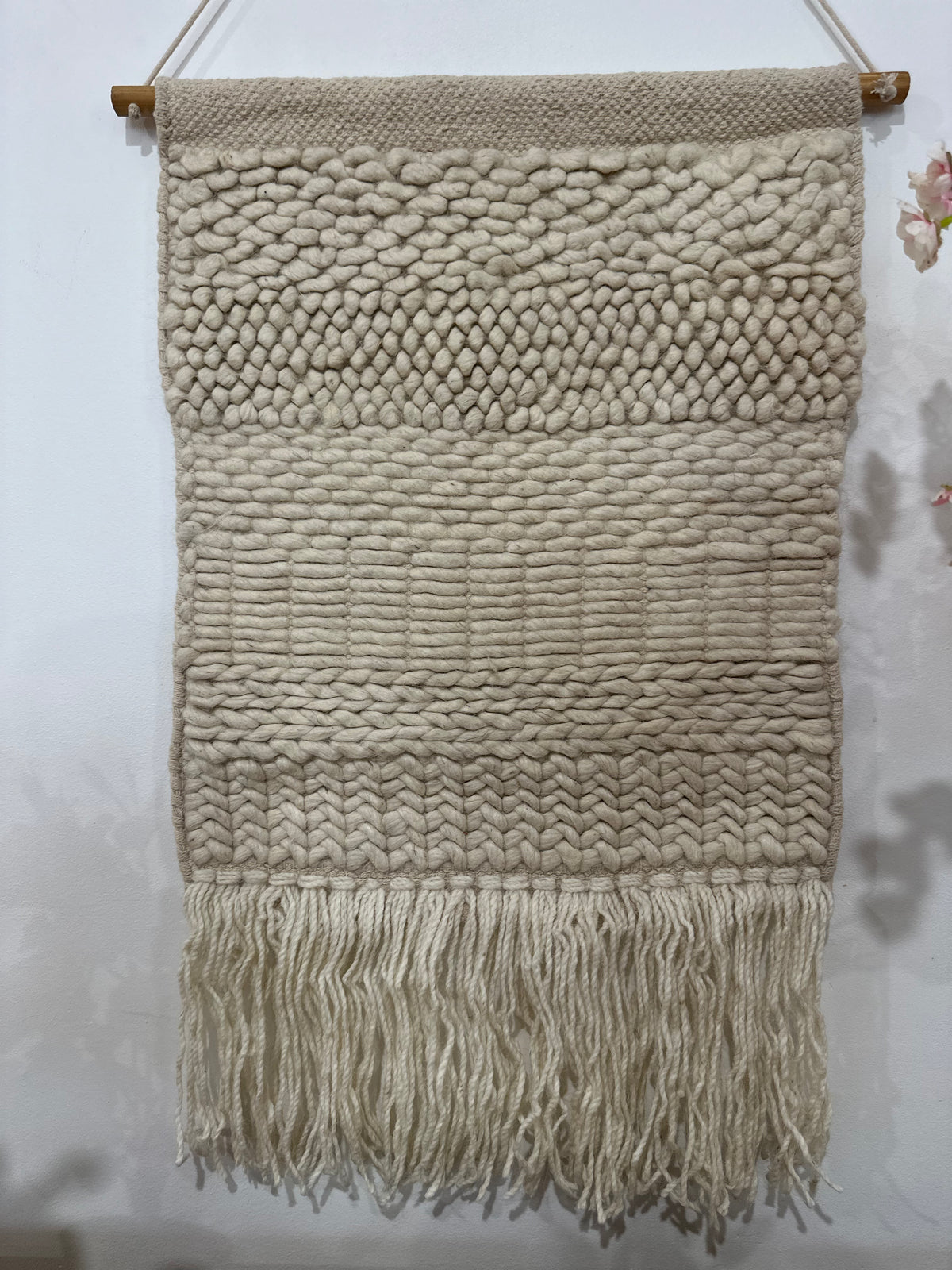 Fringed woolen wall hanging in beige and cream with textured weave – boho home decor for living room or bedroom